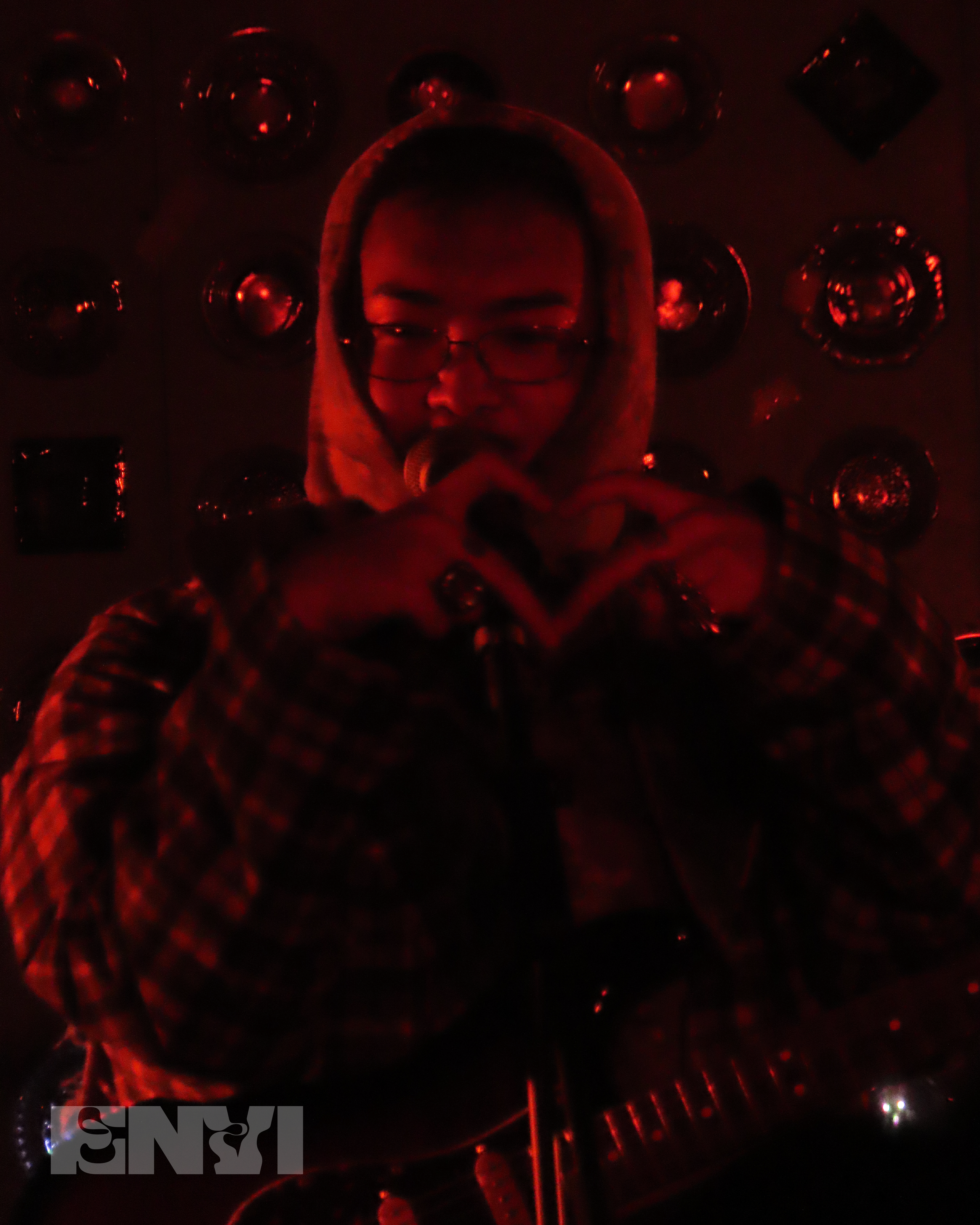 Hojean making a heart gesture by meeting his index and middle fingers together.