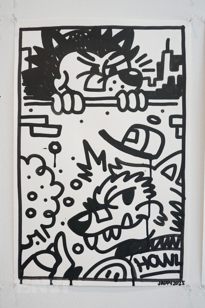 A close up of one of Jappy Agoncillo's artworks, which is a black and white doodle of Dante and Juan, two cartoon wolves.