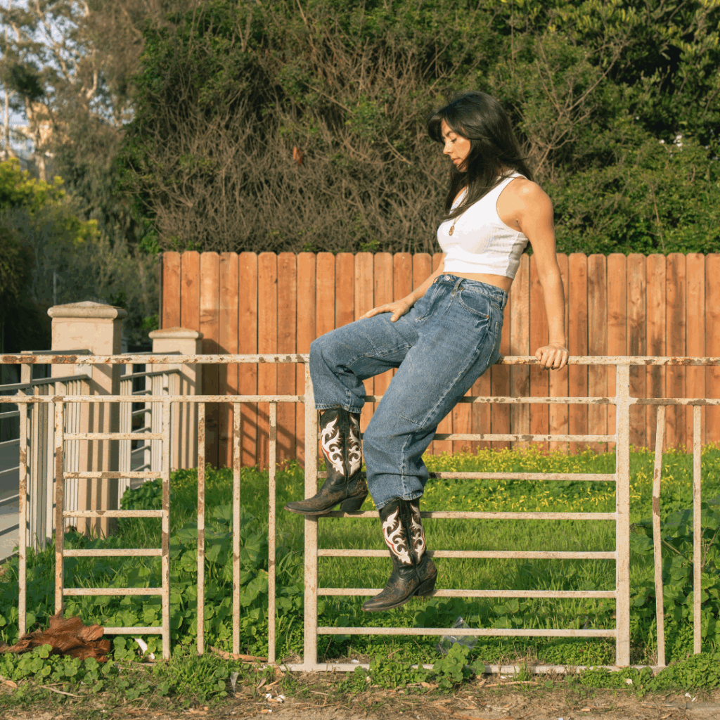 Marilyn Hucek sitting on a fence.