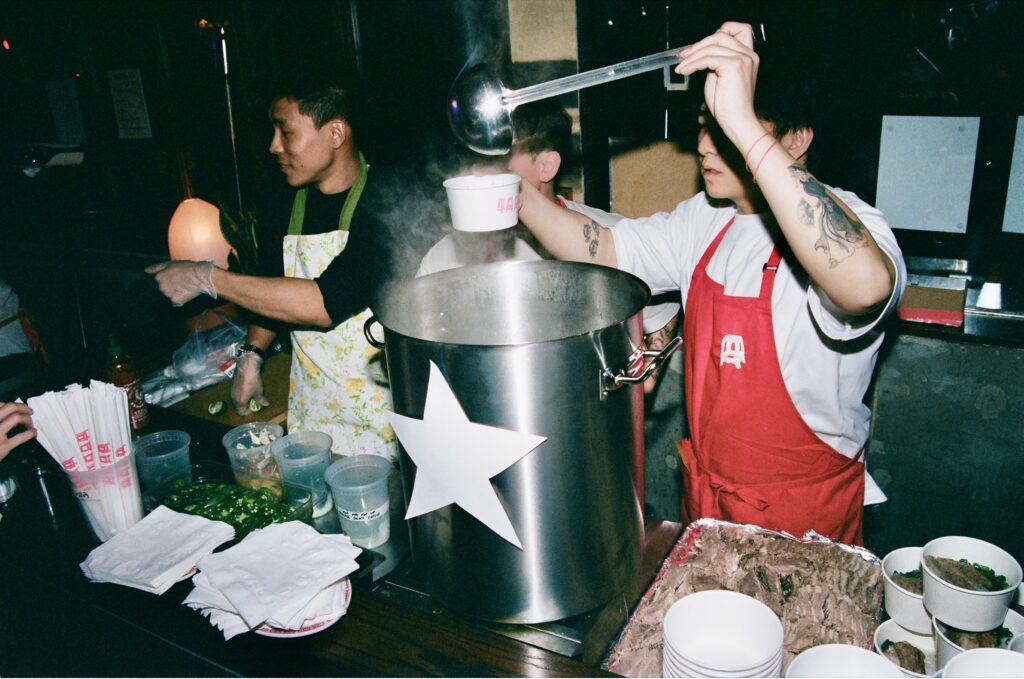 A man pouring some broth into a bowl.