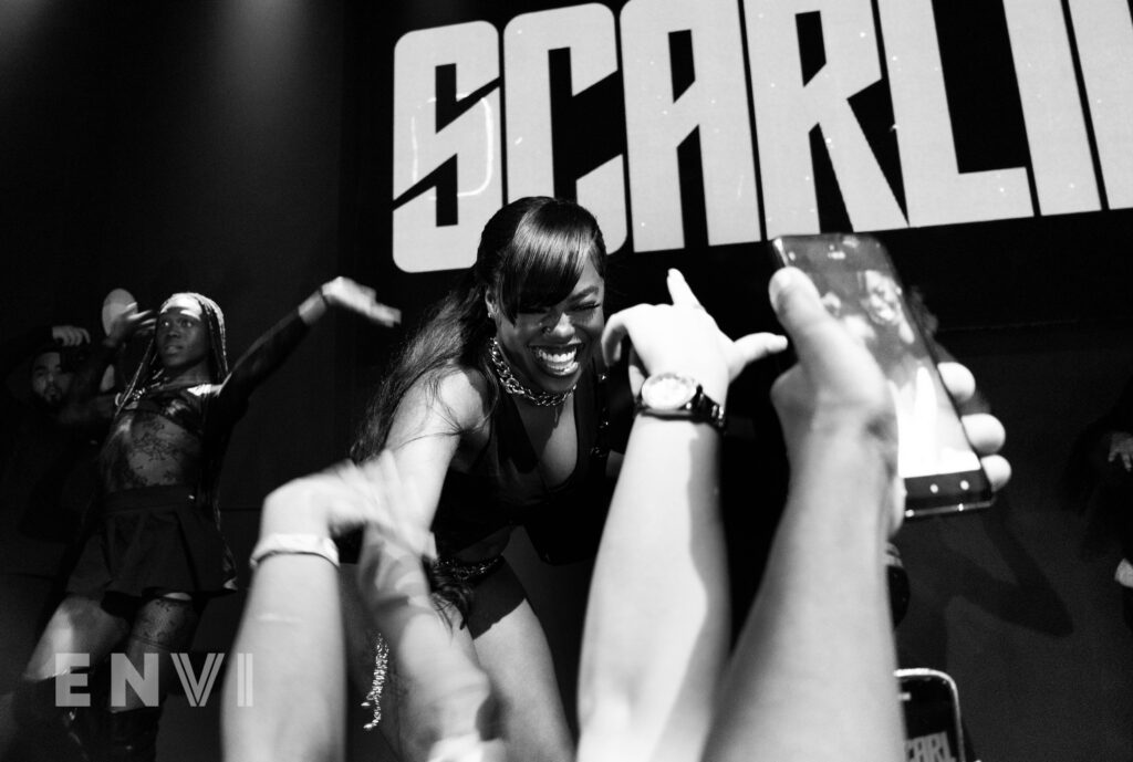 Cleotrapa performs her headline show at SOB’s on June 17, 2024 in New York City. Hands reach out to her while she smiles widely. 