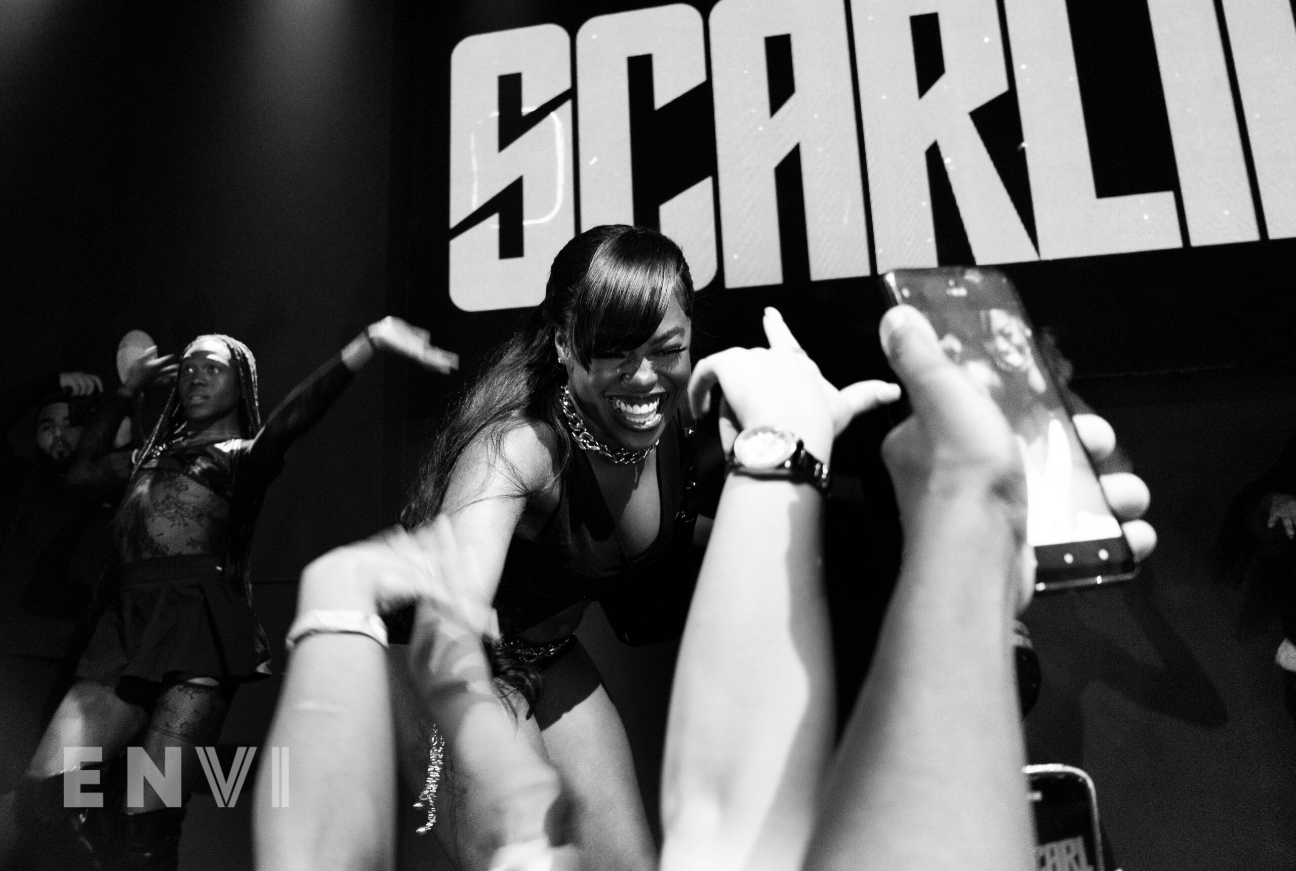 Cleotrapa performs her headline show at SOB’s on June 17, 2024 in New York City. Hands reach out to her while she smiles widely.