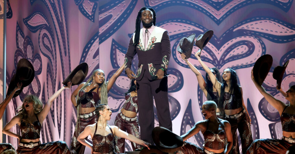 Shaboozey performs at the 67th annual Grammy Awards. He stands on stage surrounded by dancers