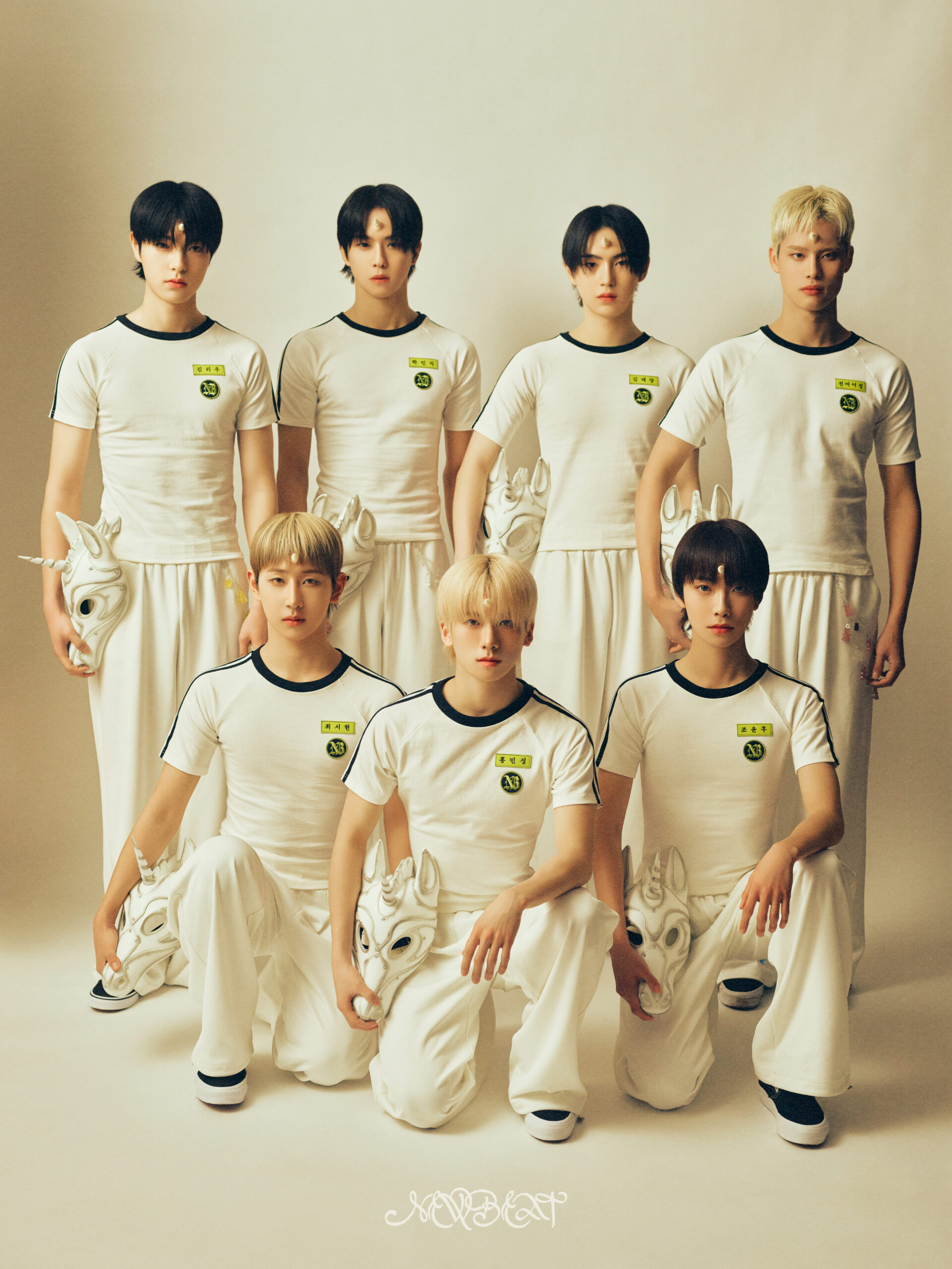 NEWBEAT group photo donning white gym uniforms.