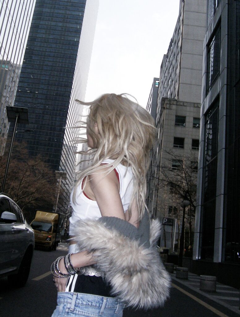 HEYOON posing with her back facing the camera.