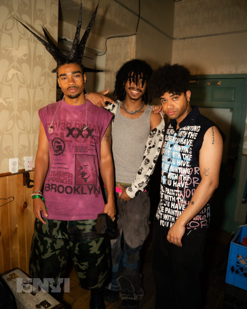 The Band RUOK pose for the camera. From L-R members Danny, Gabriel, and Nathaniel Singh stand close to one another.