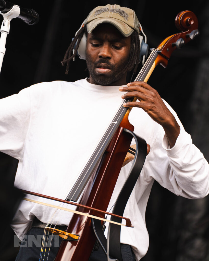 Blood Orange plays a cello on stage.